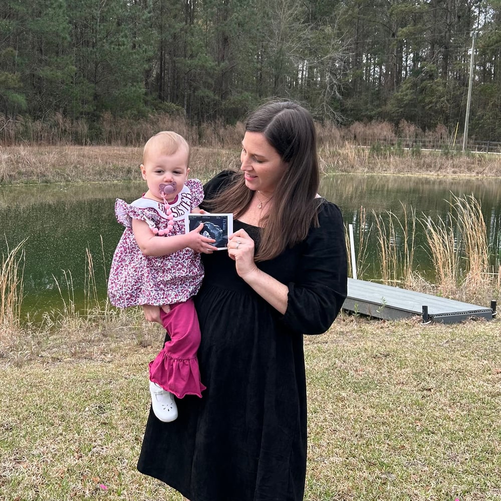 Dr. Nicole with her first daughter, revealing her second pregnancy